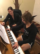 Teacher and student at a piano