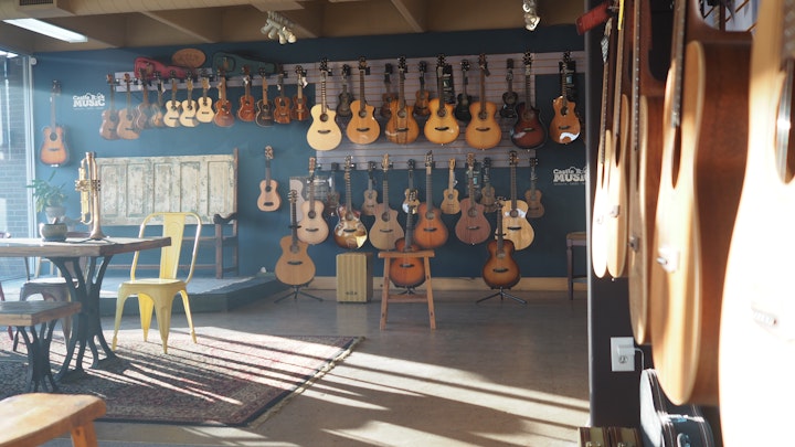 Castle Rock Music: Interior of the store, wall of guitars