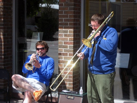 World renowned Jazz Trombonist Sam Savage performs at Castle Rock Music in front of the store with owner Jason Bower
