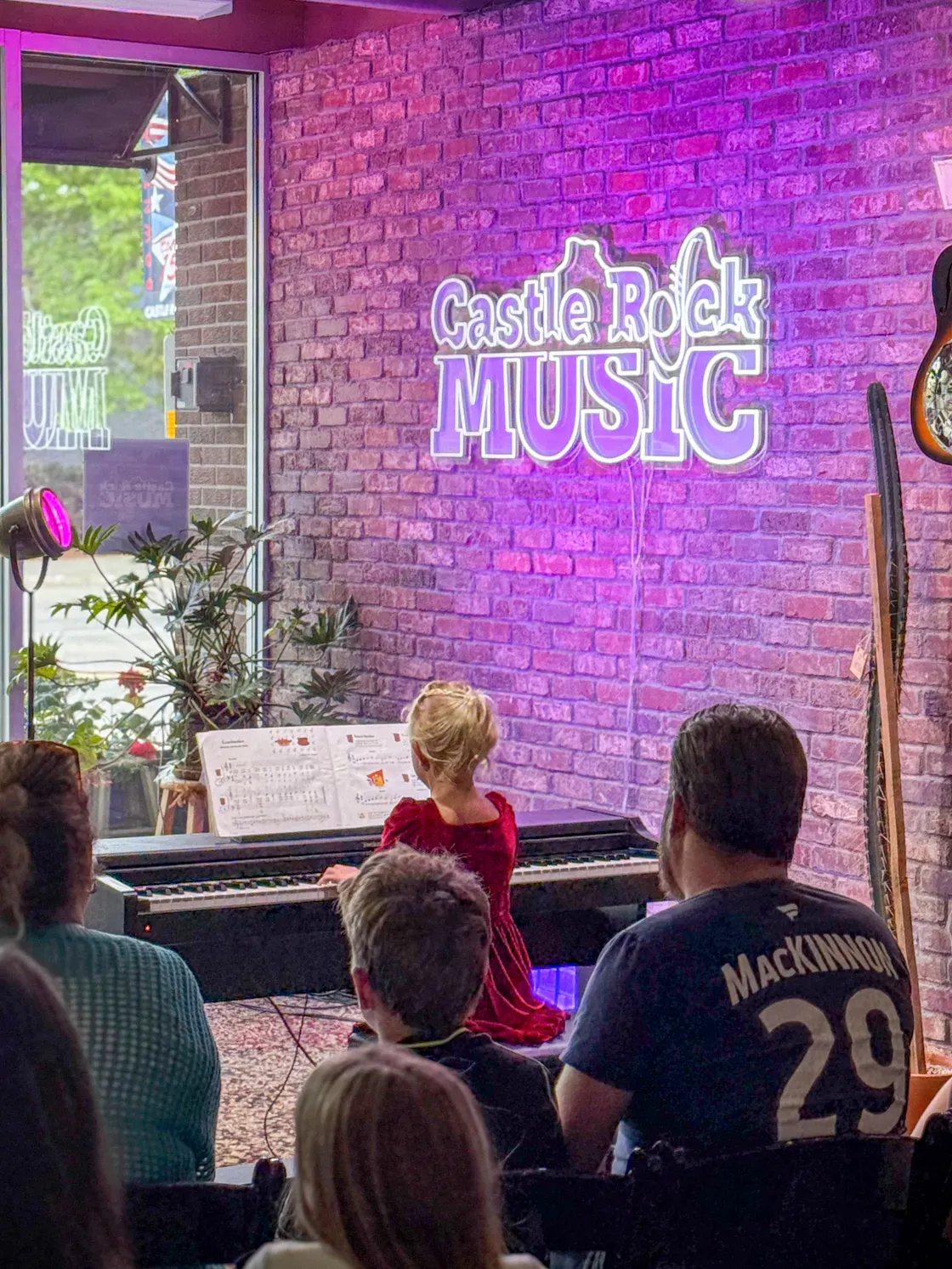 Performance: Student piano player in a red dress