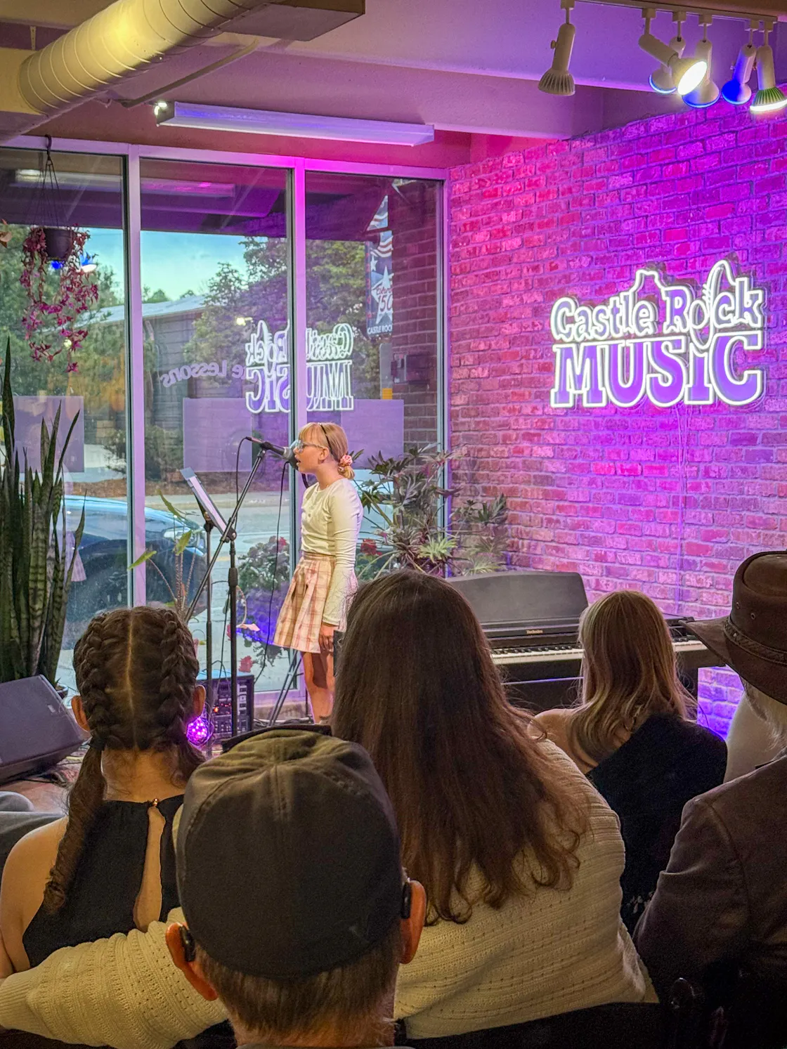 Performance: Student singer with blonde hair and audience